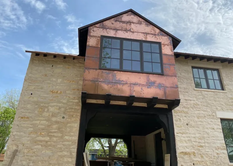 Copper metal panel facade on a stone building for Roof Repair in Montclair